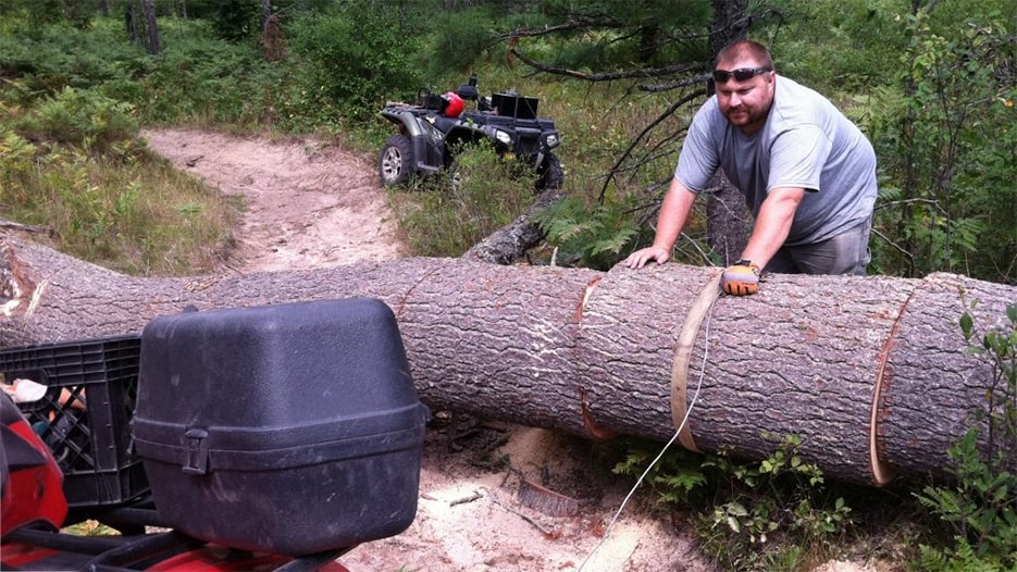 SORVA member working on clearing a large downed tree from the trail