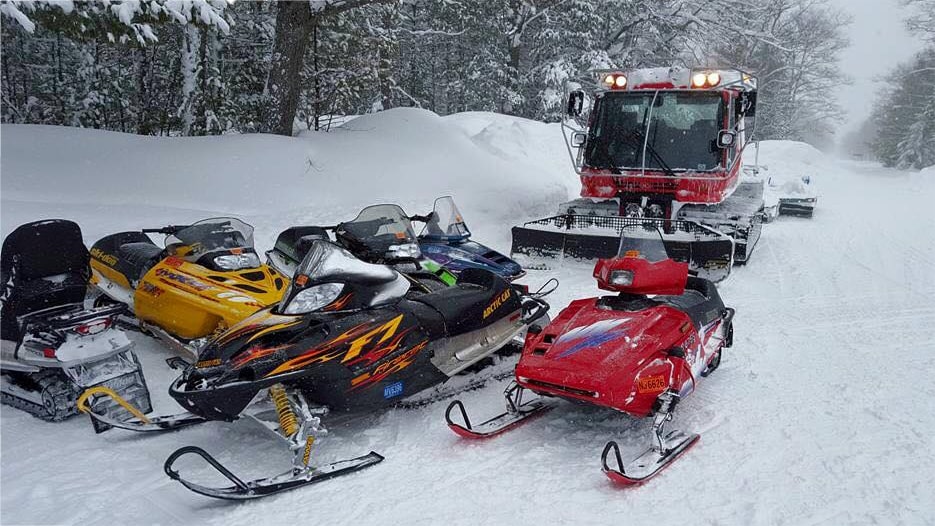 Pisten Bully groomer with snowmobiles